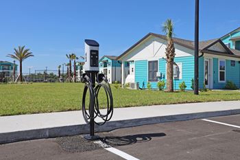 a parking meter in front of a blue house